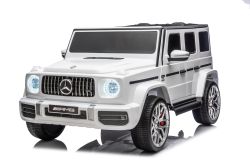 Coche eléctrico para niños Mercedes-Benz G63 AMG 4x4, dos plazas, 24V,bianco, reproductor MP3 con conexión USB/AUX y Bluetooth, tracción 4x4, batería de litio, ruedas EVA con suspensión, asientos de cuero sintético, control remoto, modelo con licencia ofi